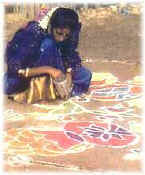 Kolam patterns being drawn with rice flour
